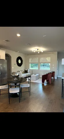 a living room with couches and a potted plant