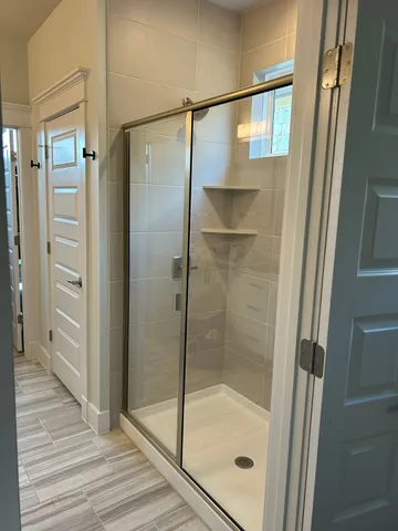 a bathroom with a glass shower door