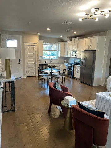 a living room with furniture and kitchen view