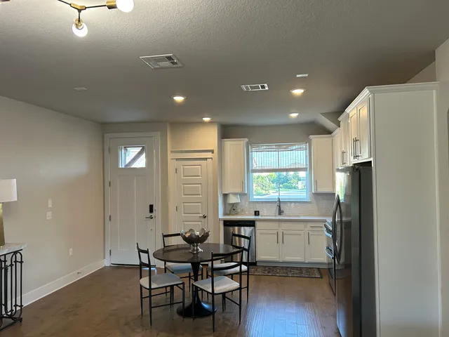 a kitchen with refrigerator and window