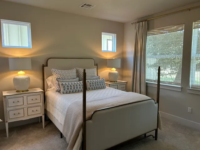 a bedroom with a bed and a night stand