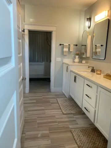 a bathroom with a sink a mirror and a toilet