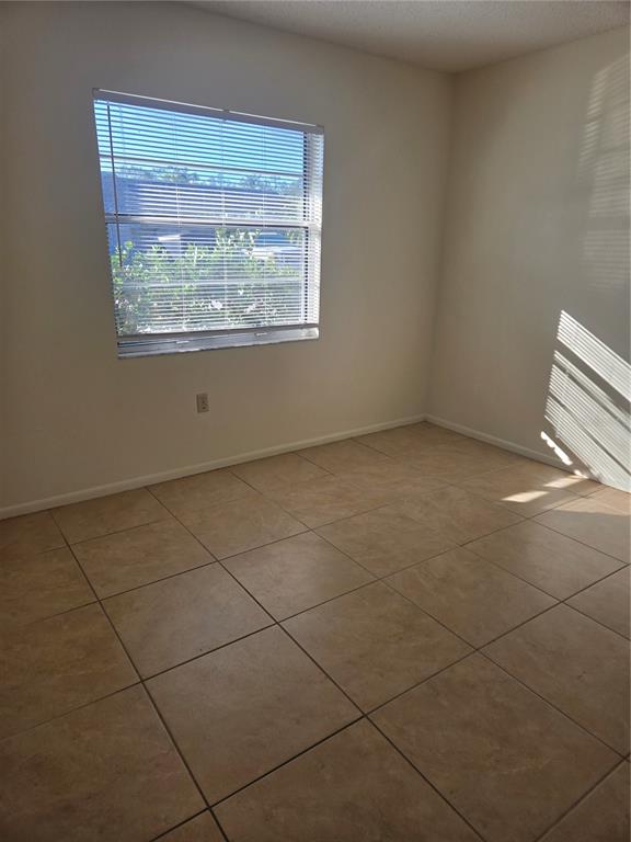 1313 54th Avenue East, Unit 1313 Bradenton, FL 34203 - Photo 11 of 17 a view of an empty room with a window