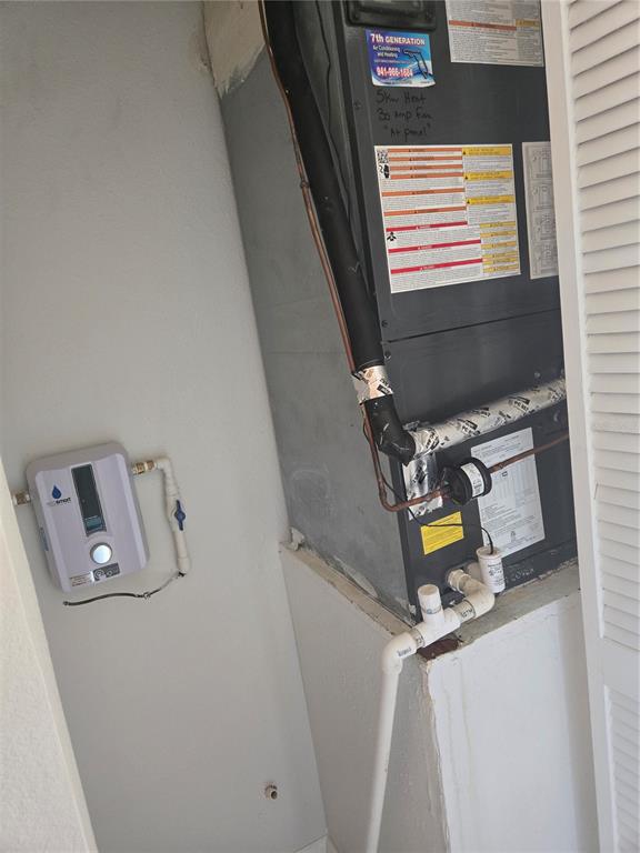 1313 54th Avenue East, Unit 1313 Bradenton, FL 34203 - Photo 14 of 17 a view of storage and utility room with washer and dryer