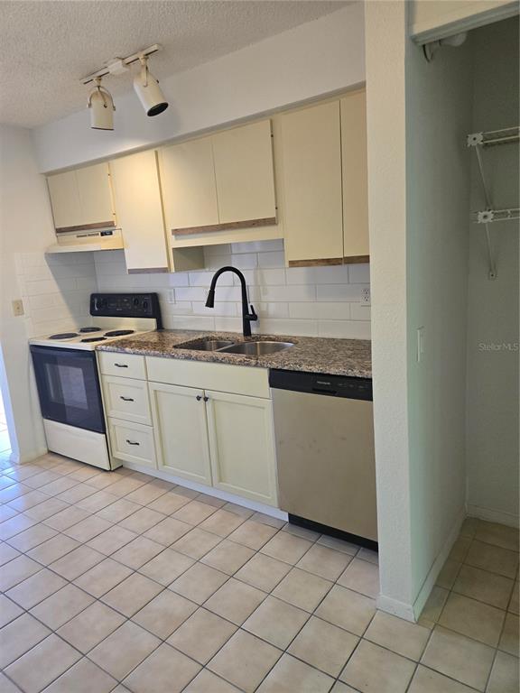 1313 54th Avenue East, Unit 1313 Bradenton, FL 34203 - Photo 6 of 17 a kitchen with a sink cabinets and appliances