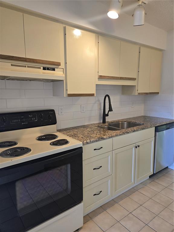 1313 54th Avenue East, Unit 1313 Bradenton, FL 34203 - Photo 7 of 17 a kitchen with granite countertop white cabinets and white appliances
