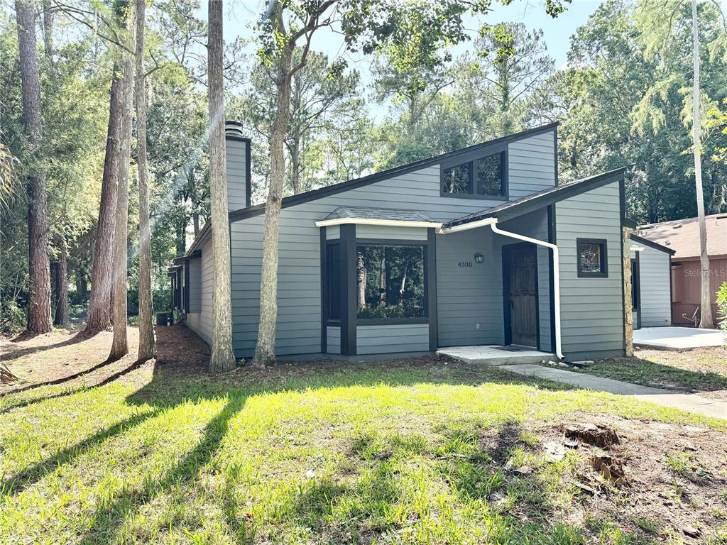 4300 Northeast 17th Terrace Gainesville, FL 32609 - Photo 1 of 21 a view of a house with a yard