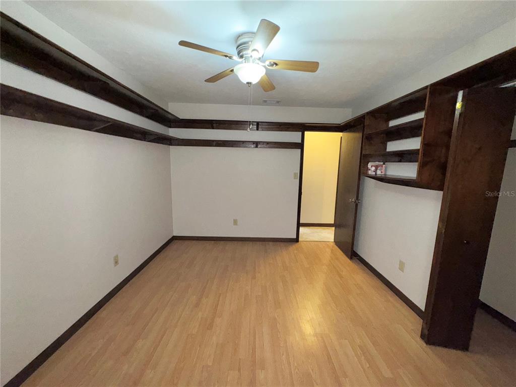 4300 Northeast 17th Terrace Gainesville, FL 32609 - Photo 12 of 21 a view of a livingroom with a ceiling fan and wooden floor