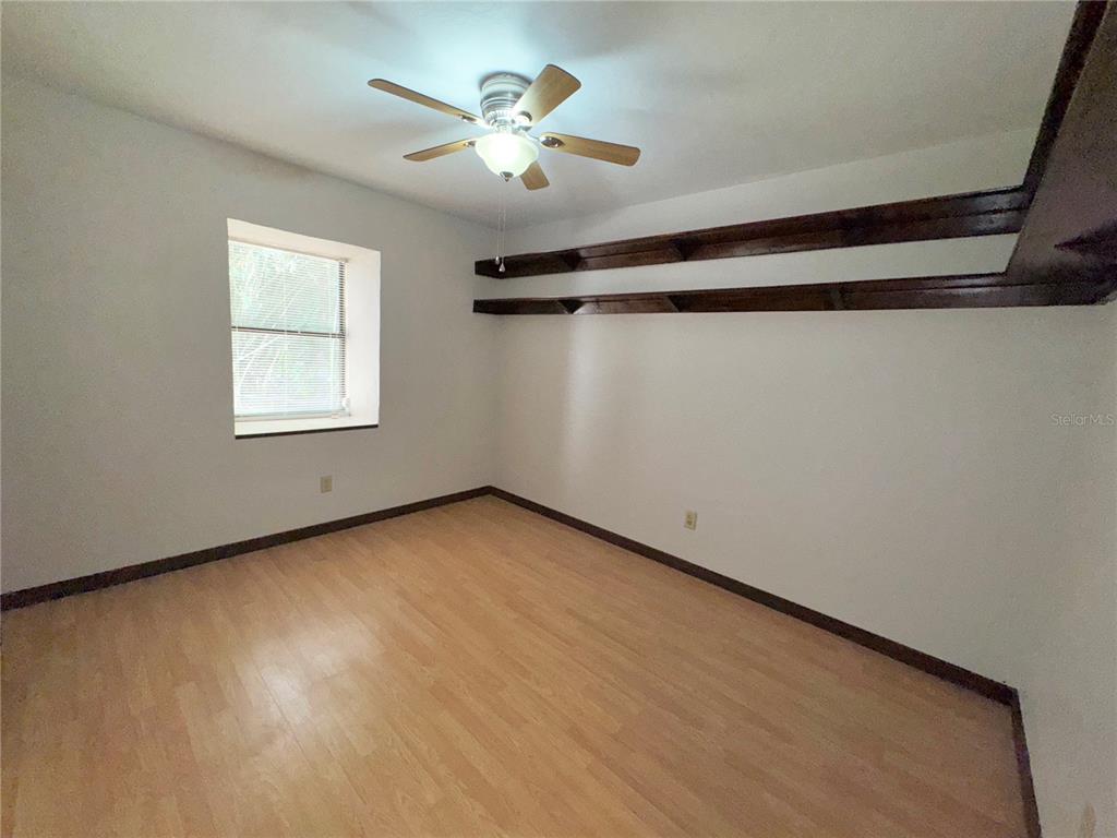 4300 Northeast 17th Terrace Gainesville, FL 32609 - Photo 13 of 21 wooden floor in an empty room with a window