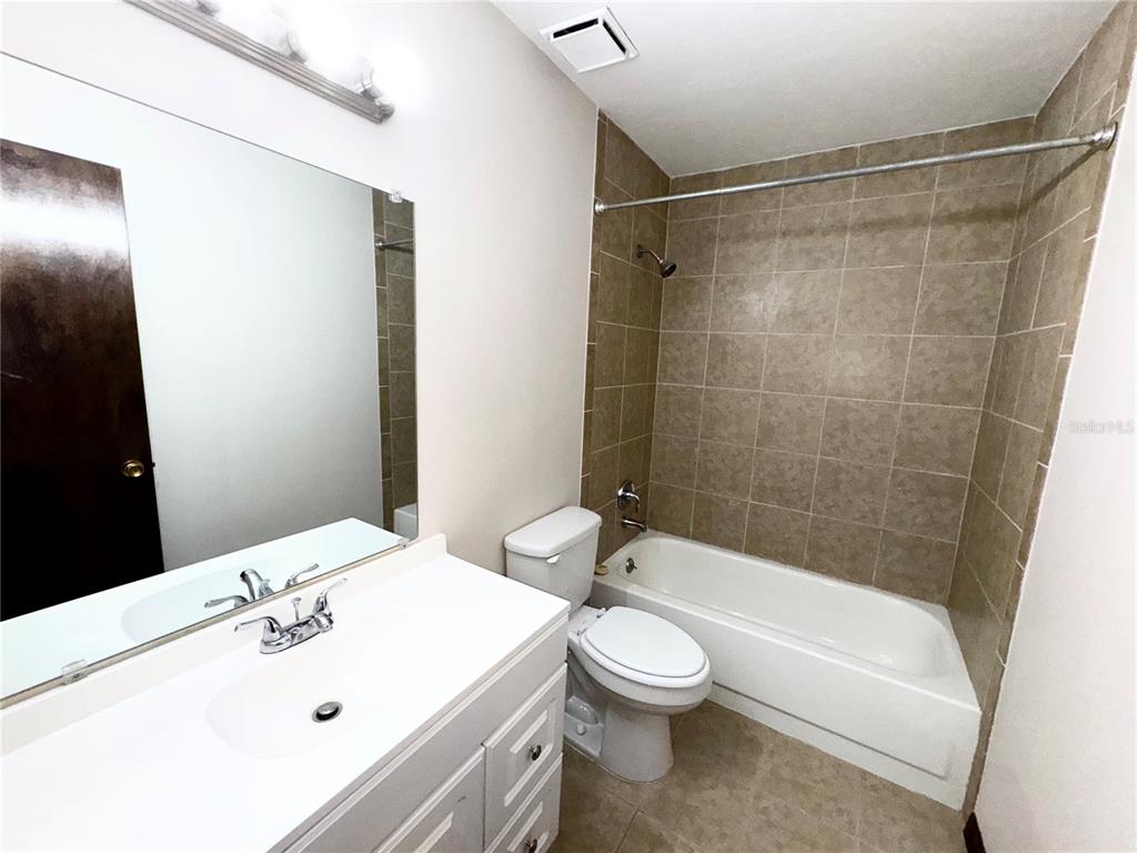 4300 Northeast 17th Terrace Gainesville, FL 32609 - Photo 14 of 21 a bathroom with a bathtub shower sink vanity and toilet