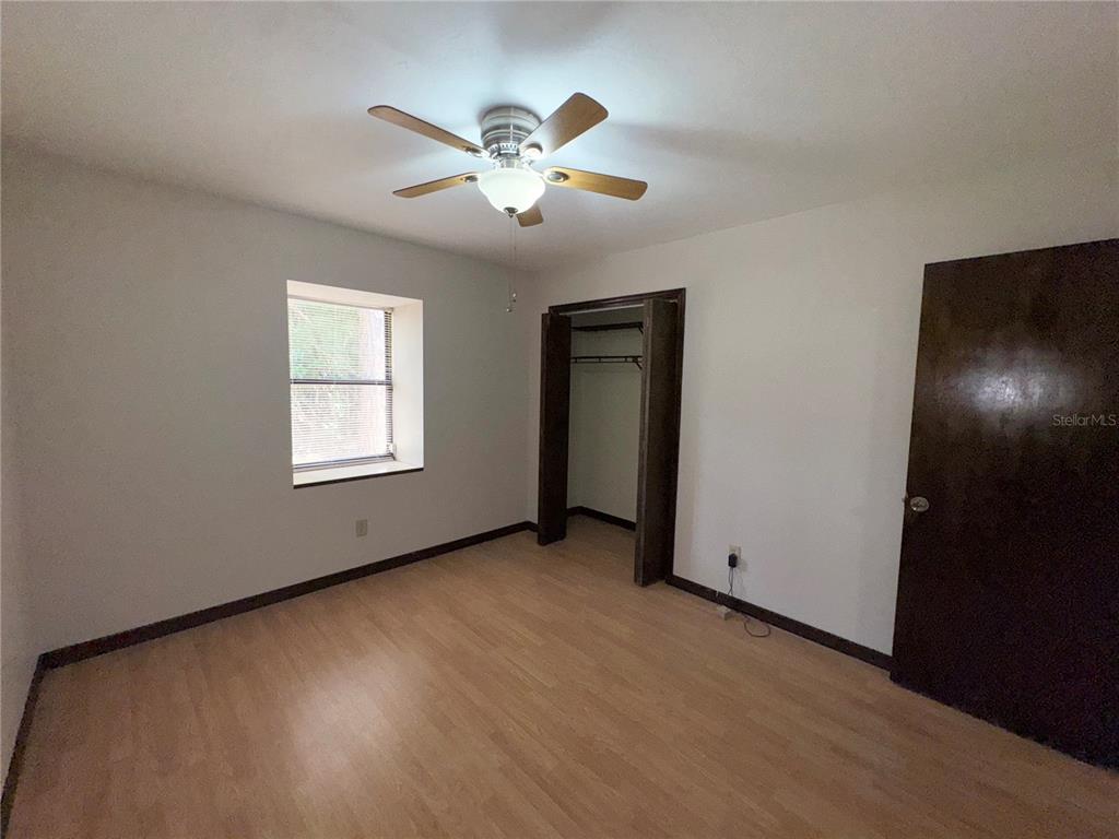 4300 Northeast 17th Terrace Gainesville, FL 32609 - Photo 15 of 21 an empty room with chandelier fan and windows