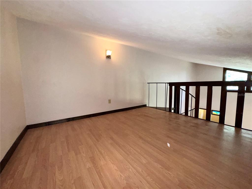 4300 Northeast 17th Terrace Gainesville, FL 32609 - Photo 6 of 21 a view of an empty room with wooden floor