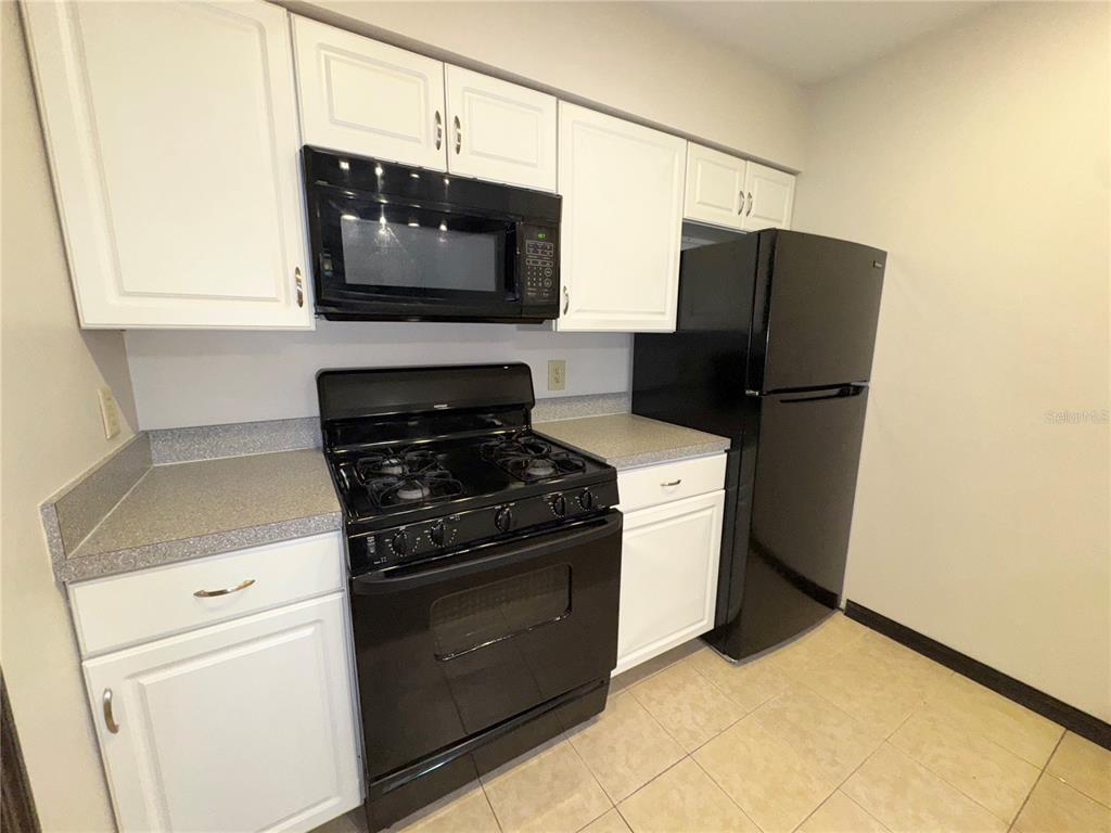 4300 Northeast 17th Terrace Gainesville, FL 32609 - Photo 8 of 21 a kitchen with stainless steel appliances a stove microwave and refrigerator