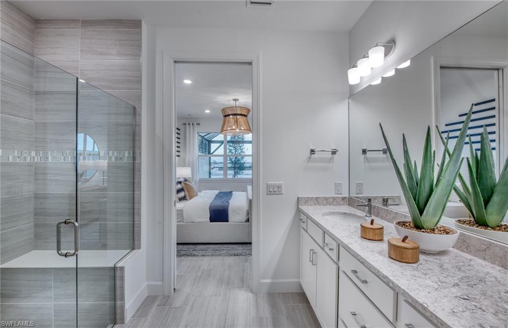 12669 Pyrite Court Alva, FL 33920 - Photo 11 of 13 a bathroom with a granite countertop sink a mirror and a shower
