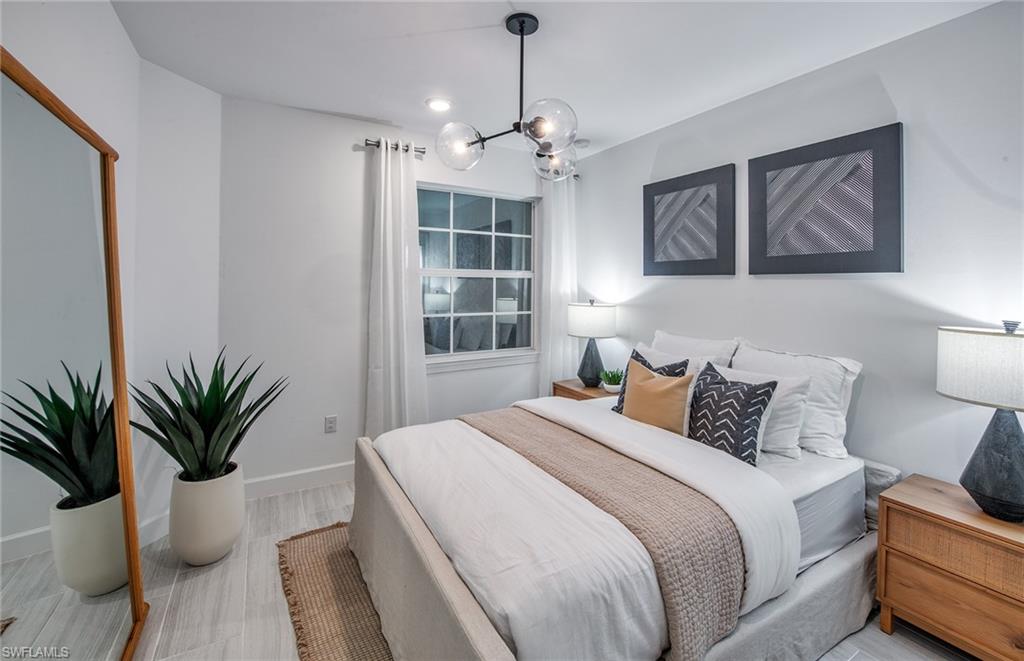 12669 Pyrite Court Alva, FL 33920 - Photo 13 of 13 a bedroom with a large bed and a chandelier
