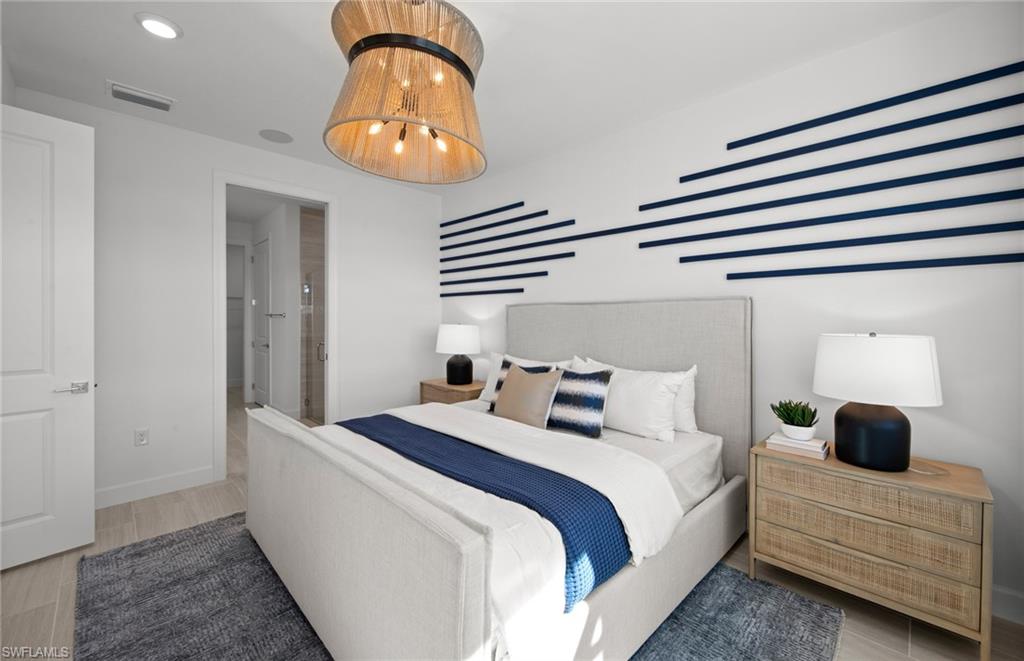 12669 Pyrite Court Alva, FL 33920 - Photo 9 of 13 a bedroom with a bed and a chandelier