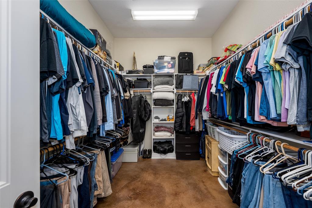 5033 Brook Lane Anna, TX 75409 - Photo 14 of 35 a view of walk in closet with clothes and shoes