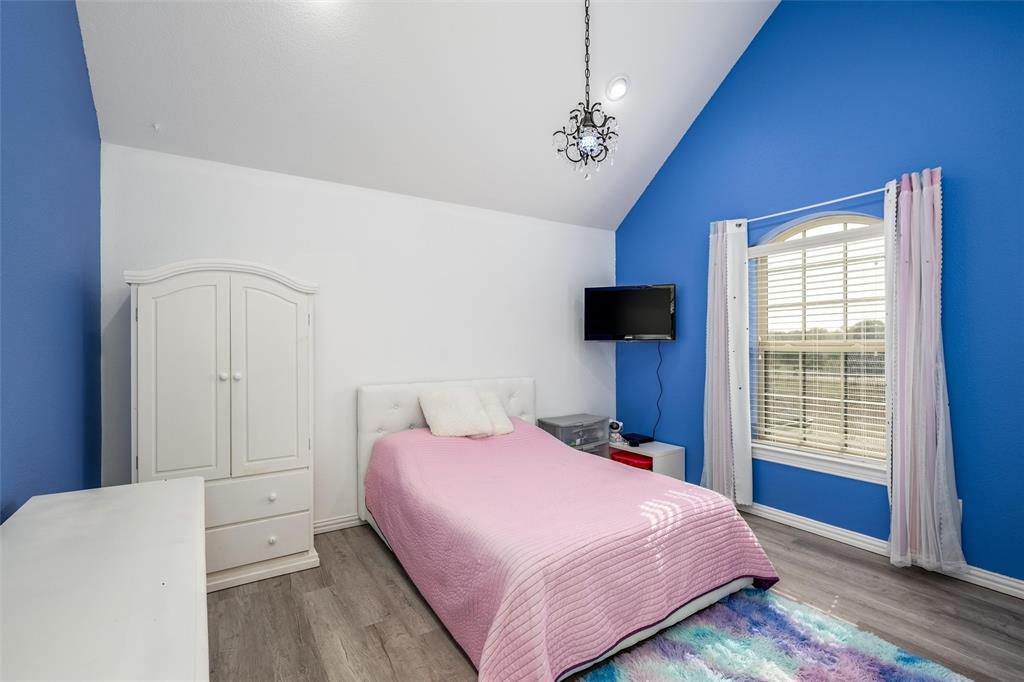 5033 Brook Lane Anna, TX 75409 - Photo 18 of 35 a bedroom with a bed and a television