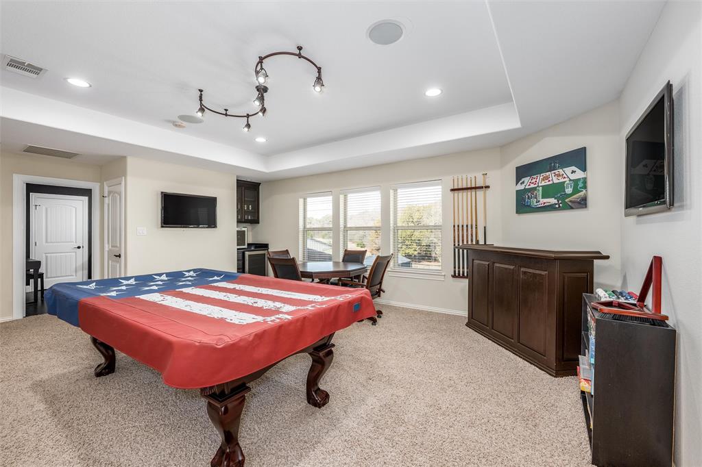 5033 Brook Lane Anna, TX 75409 - Photo 23 of 35 a bedroom with furniture and a flat screen tv