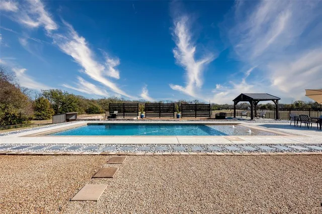 a view of a swimming pool with a yard