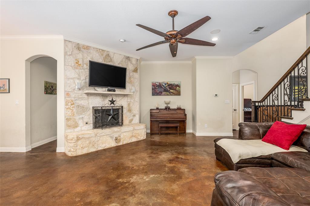 5033 Brook Lane Anna, TX 75409 - Photo 6 of 35 a living room with furniture a flat screen tv and a fireplace