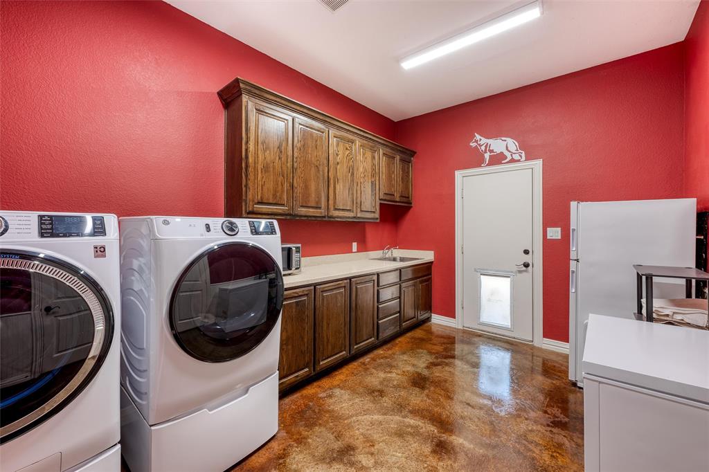 5033 Brook Lane Anna, TX 75409 - Photo 10 of 35 a utility room with cabinets washer and dryer