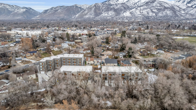 4016 South Burch Way Ogden, UT 84405 - Photo 26 of 30 Modern multi-story residential buildings featuring balconies and gray facades, situated within a developed area with extensive tree cover