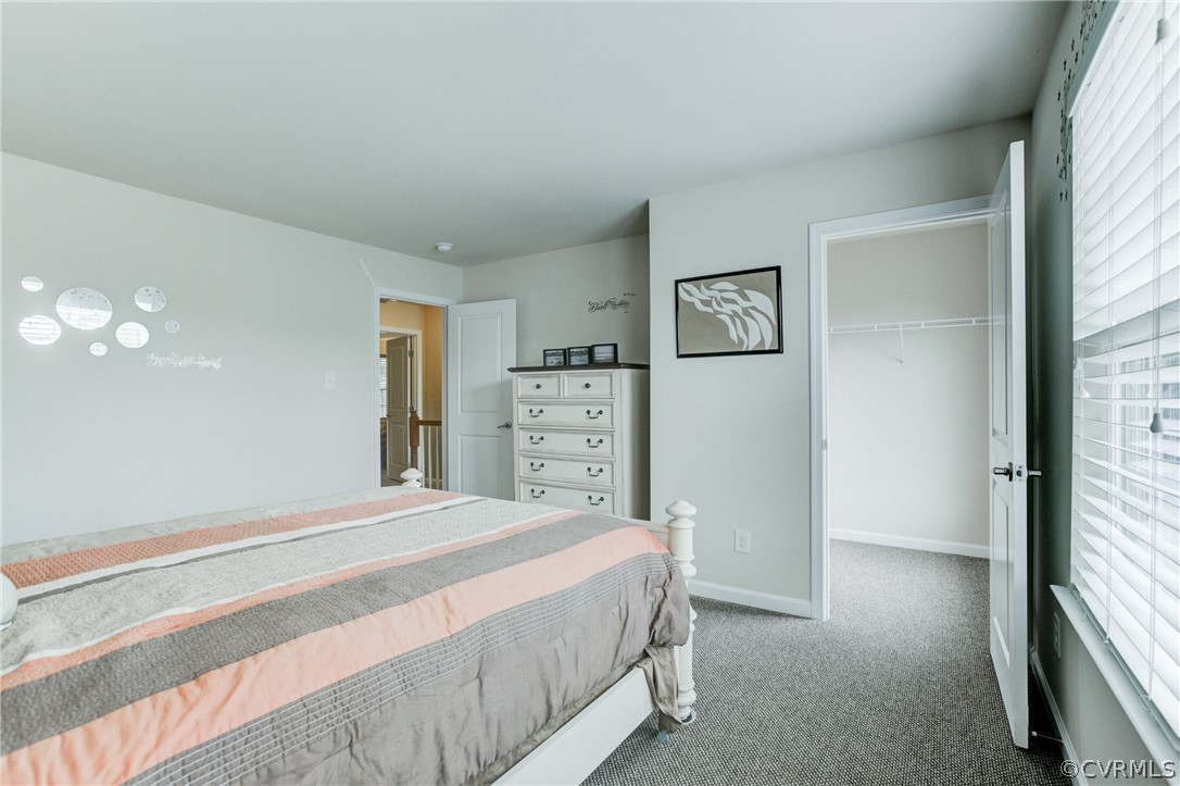 3602 Avocado Drive Midlothian, VA 23112 - Photo 21 of 39 a spacious bedroom with a bed and a chandelier