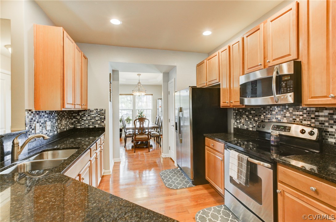 3602 Avocado Drive Midlothian, VA 23112 - Photo 8 of 39 a kitchen with stainless steel appliances granite countertop a stove a sink and a microwave