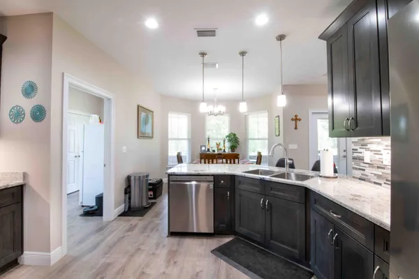 a kitchen with lots of counter space a sink appliances and cabinets