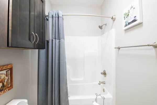 a bathroom with a shower and a mirror