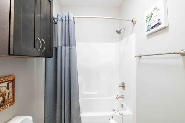 a bathroom with a shower and a mirror