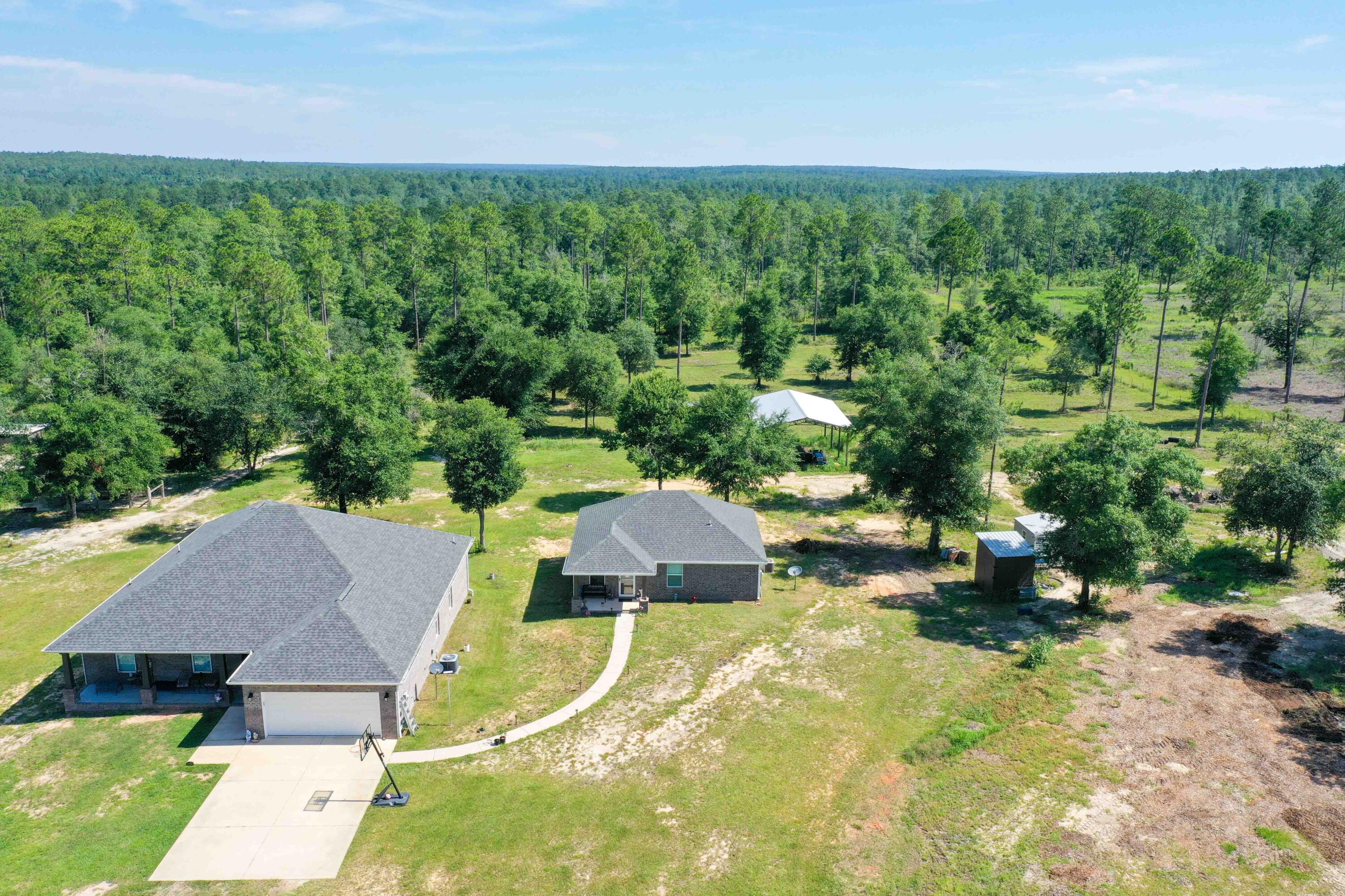 6249 Highway 4 Baker, FL 32531 - Photo 2 of 37 an aerial view of a house with swimming pool and garden