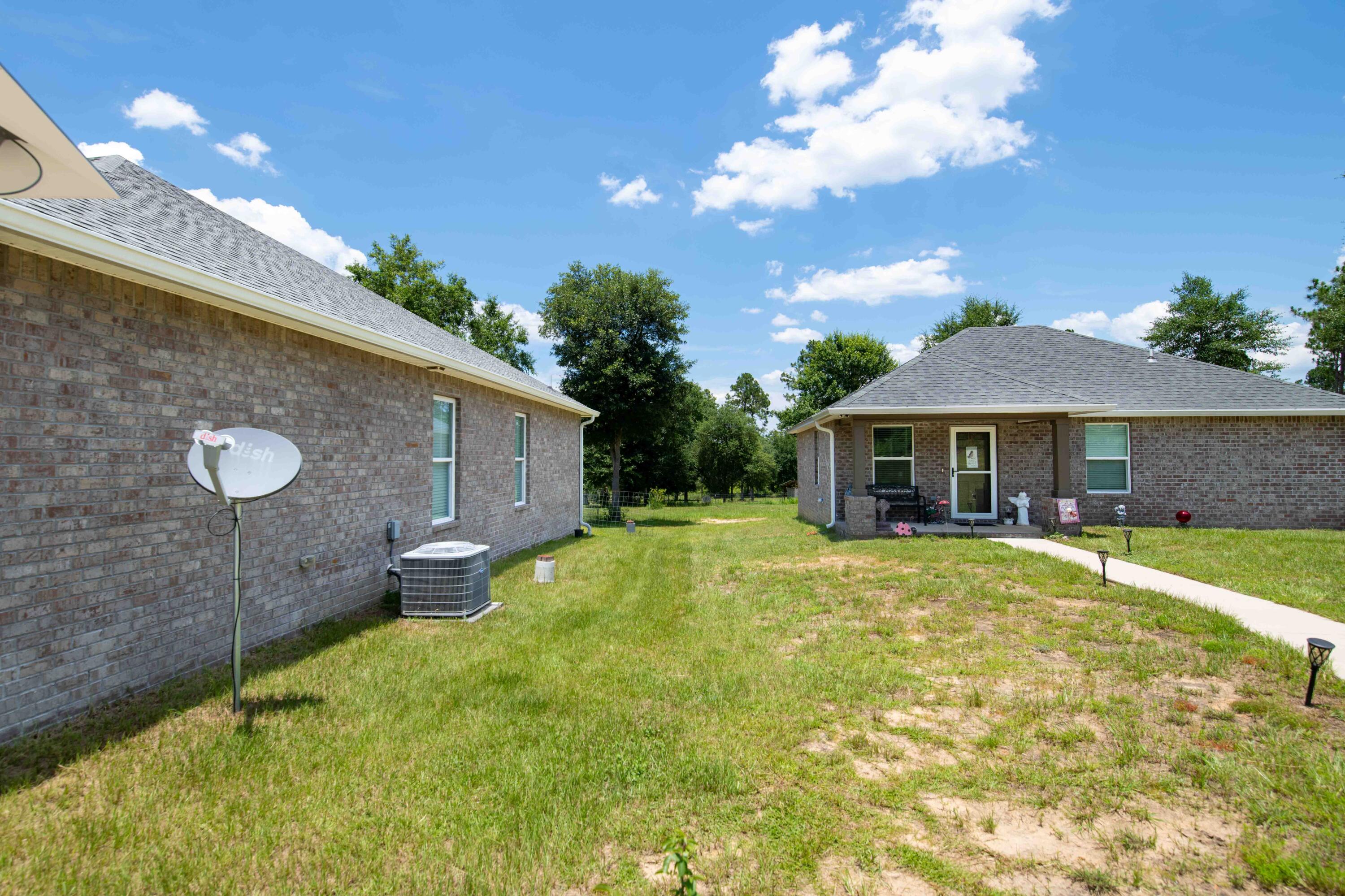 6249 Highway 4 Baker, FL 32531 - Photo 21 of 37 a front view of house with yard and patio