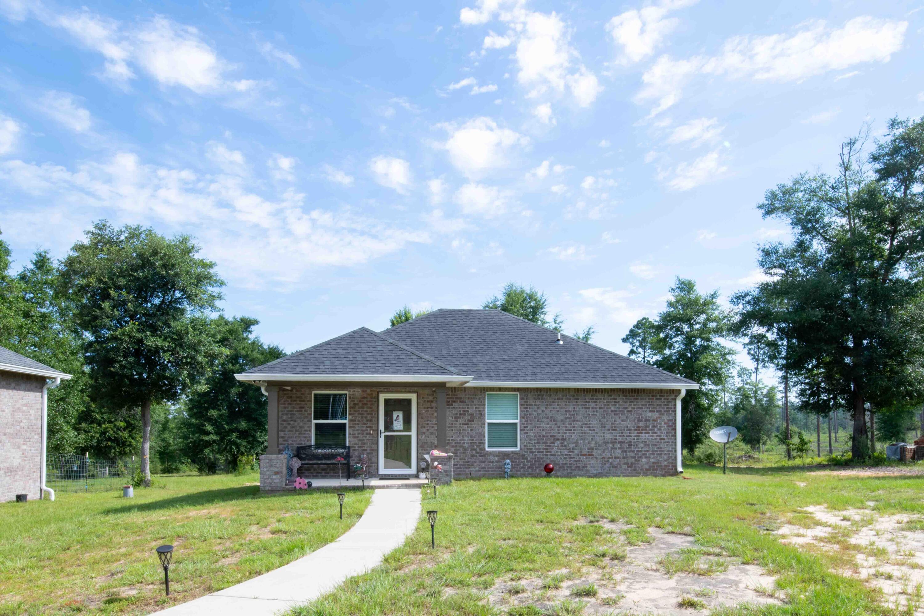 6249 Highway 4 Baker, FL 32531 - Photo 22 of 37 a front view of a house with garden