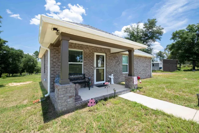 a view of a garden with a house