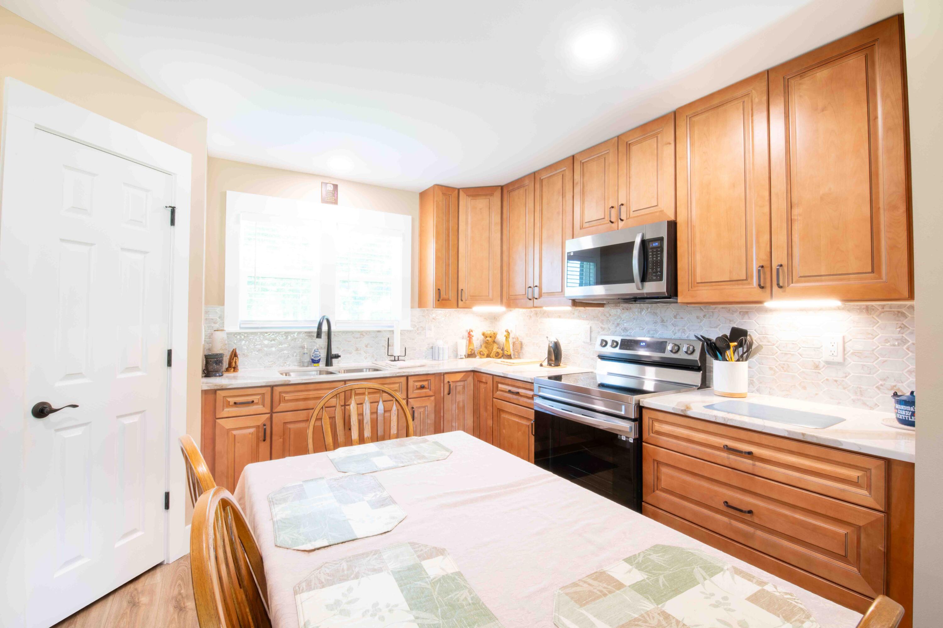 6249 Highway 4 Baker, FL 32531 - Photo 26 of 37 a kitchen with stainless steel appliances granite countertop a stove top oven a sink dishwasher and a refrigerator with the cabinets