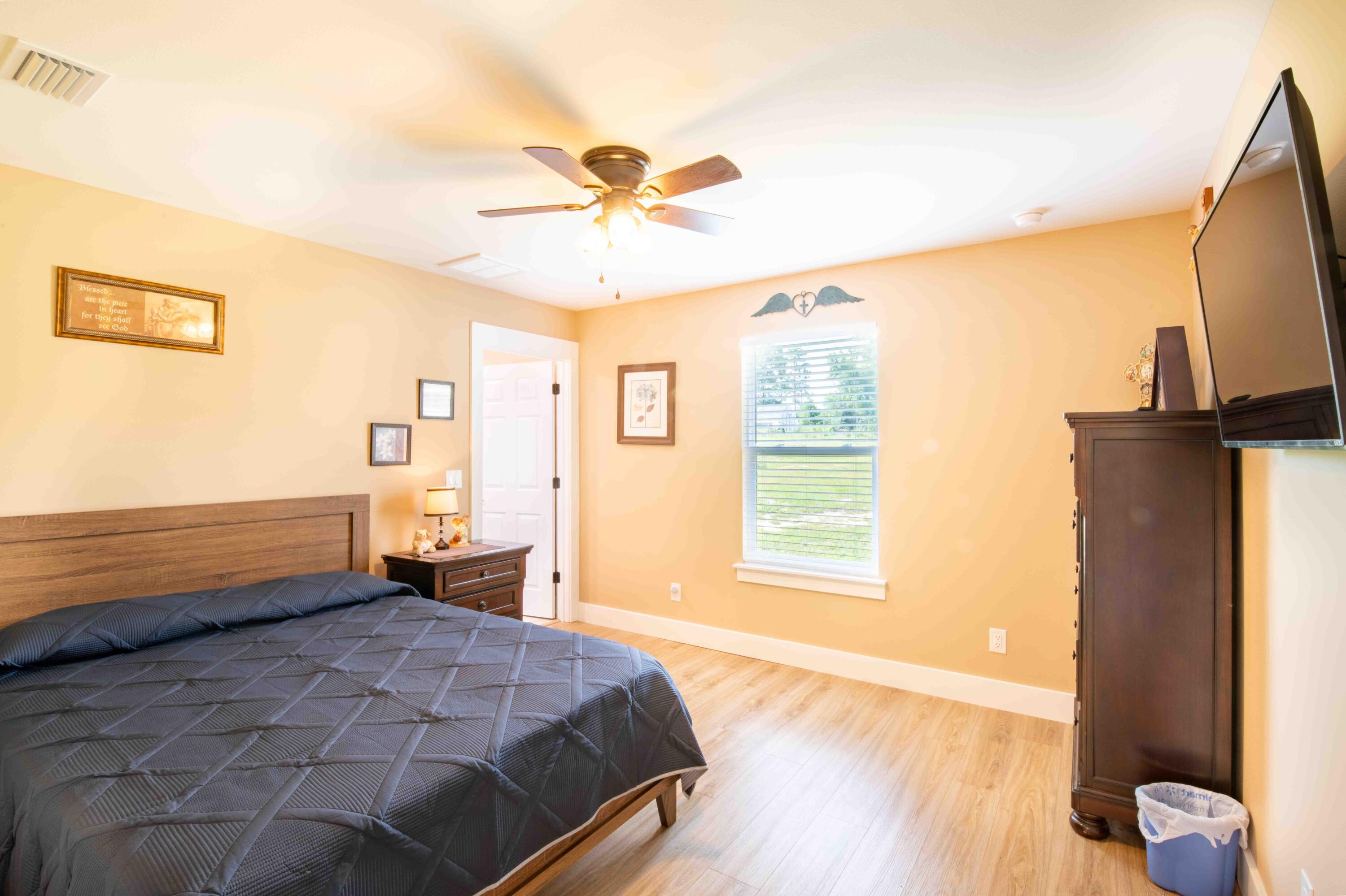 6249 Highway 4 Baker, FL 32531 - Photo 30 of 37 a bedroom with a bed and wooden floor