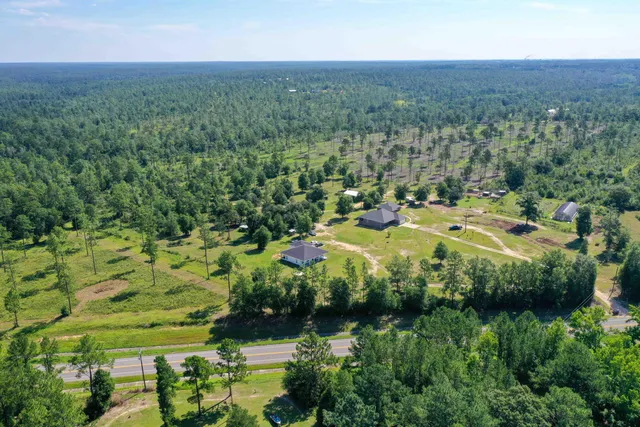 an aerial view of a house with yard swimming pool and outdoor seating