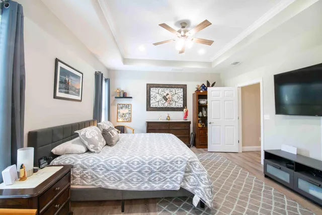 a bedroom with a bed and a flat screen tv