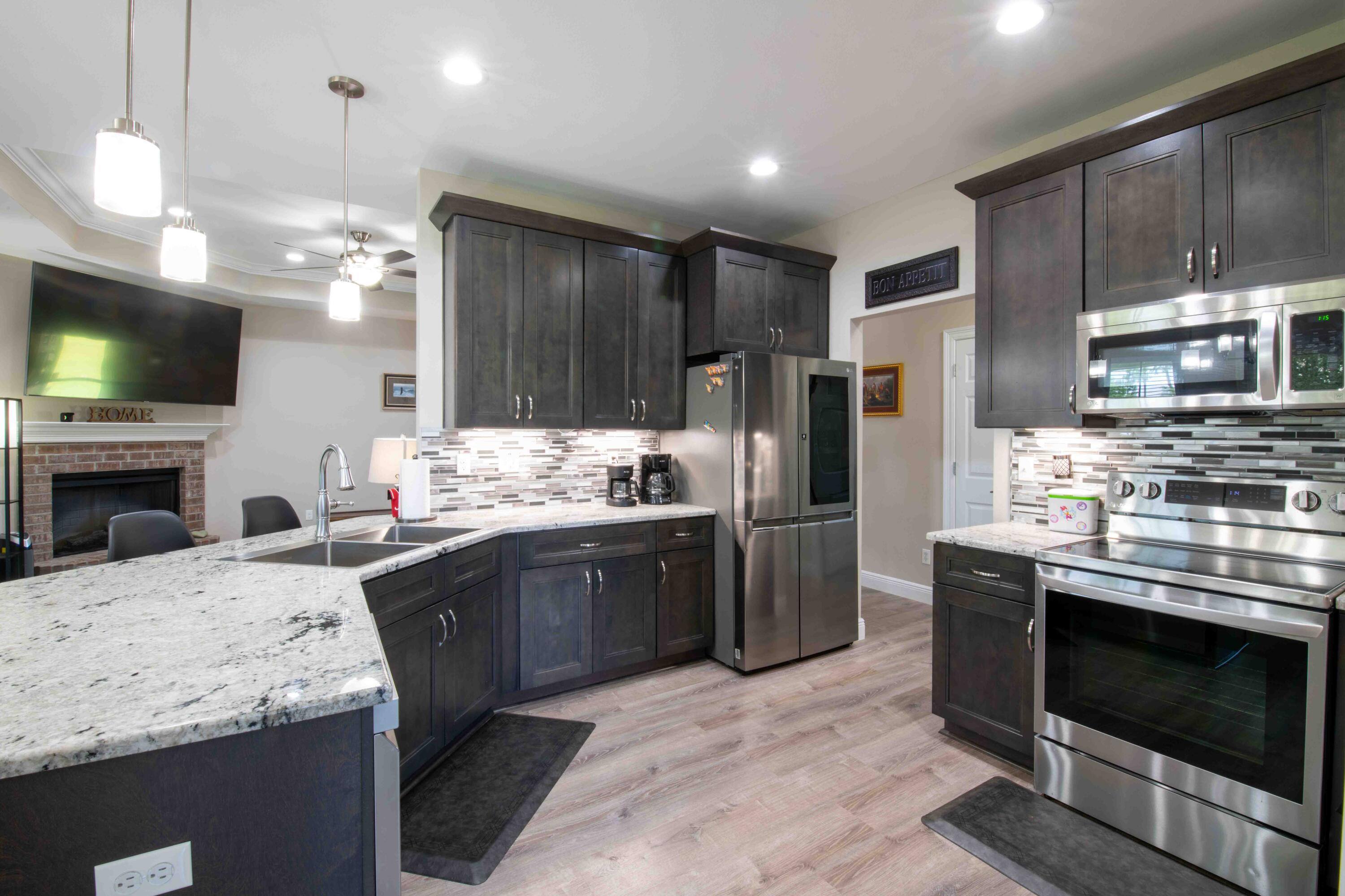 6249 Highway 4 Baker, FL 32531 - Photo 10 of 37 a kitchen with stainless steel appliances kitchen island granite countertop a stove refrigerator sink and microwave