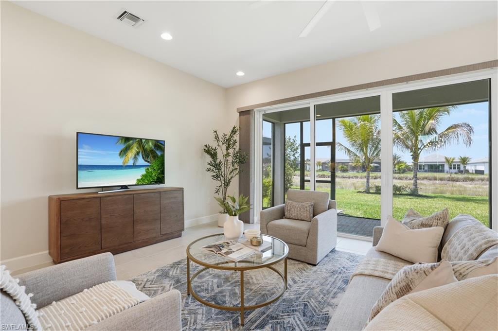 12391 Purple Ficus Way Naples, FL 34120 - Photo 14 of 47 a living room with furniture and a flat screen tv