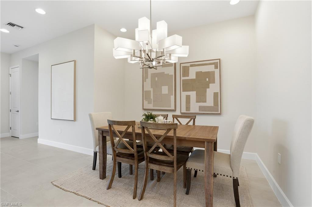 12391 Purple Ficus Way Naples, FL 34120 - Photo 15 of 47 a view of a dining room with furniture and a chandelier