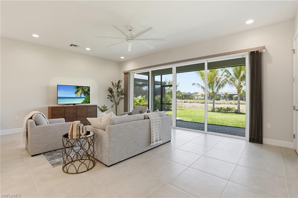 12391 Purple Ficus Way Naples, FL 34120 - Photo 17 of 47 a living room with furniture and a flat screen tv