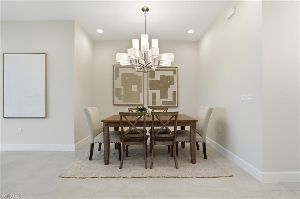 12391 Purple Ficus Way Naples, FL 34120 - Photo 18 of 47 a view of a dining room with furniture and chandelier
