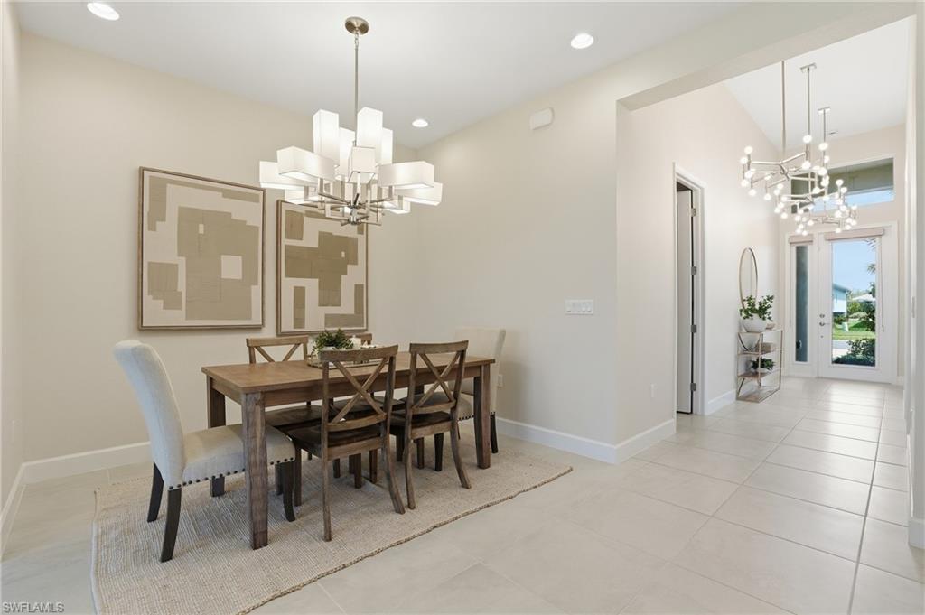 12391 Purple Ficus Way Naples, FL 34120 - Photo 19 of 47 a view of a dining room with furniture and chandelier