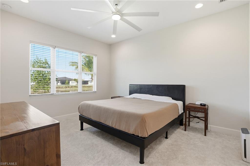 12391 Purple Ficus Way Naples, FL 34120 - Photo 18 of 44 Large Primary suite to enjoy views of lake and preserve. Fantastic natural light, large light/fan and blinds.