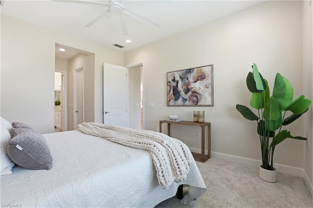 12391 Purple Ficus Way Naples, FL 34120 - Photo 25 of 47 a bedroom with a bed and a potted plant