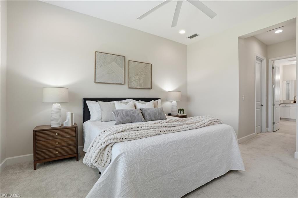 12391 Purple Ficus Way Naples, FL 34120 - Photo 26 of 47 a bedroom with bed and a chandelier