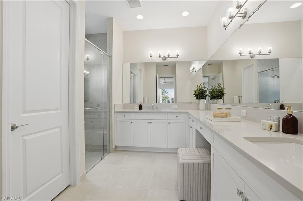 12391 Purple Ficus Way Naples, FL 34120 - Photo 27 of 47 a bathroom with a sink vanity granite tub and a large mirror